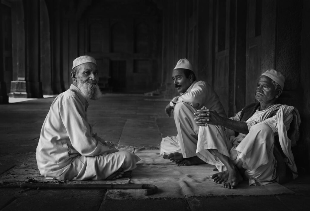 Indian men A group of Indian men sitting outdoor, India - stock photo