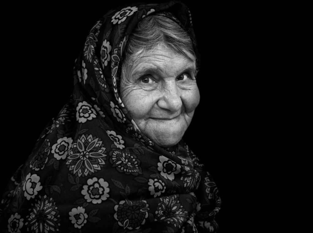 Grandma Portrait of an Iranian woman wearing traditional floreal chador in Zoroastrian village - stock photo