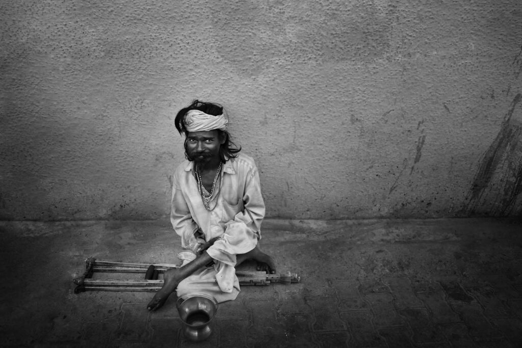 Indian Man High angle view of man sitting on the street, India - stock photo