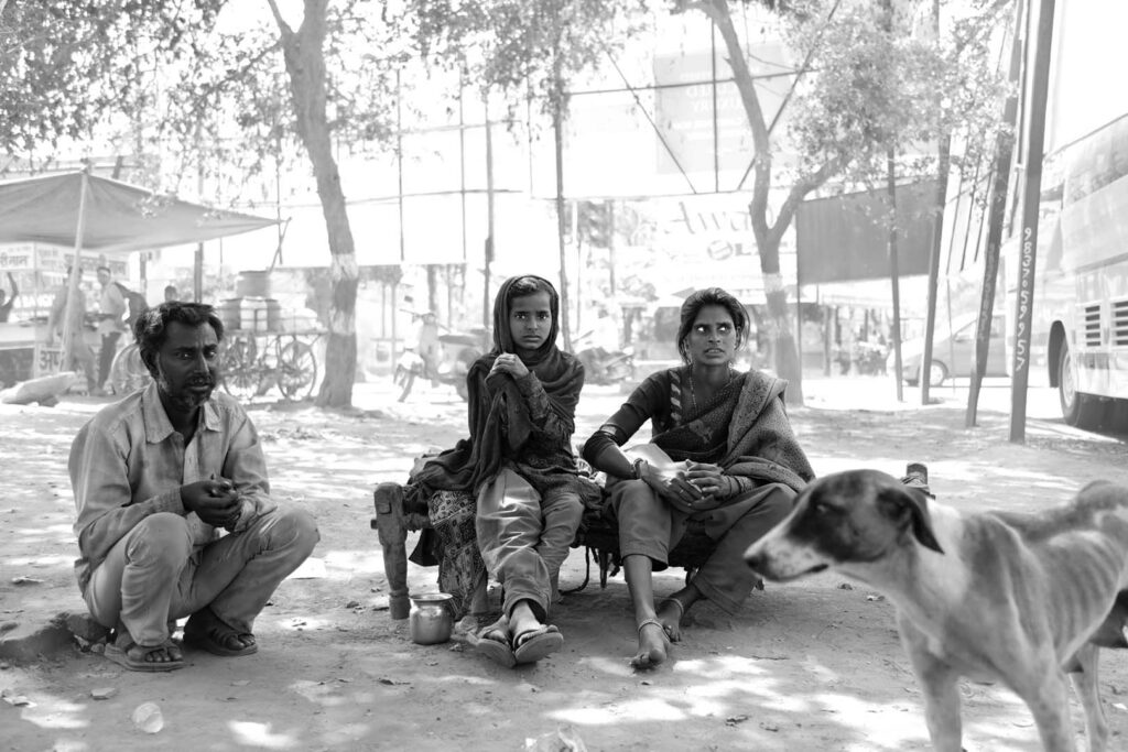In the city Indian family sitting on the street, India - stock photo